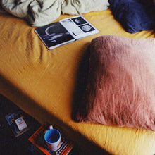 Load image into Gallery viewer, Organic French linen pillowcase in orange and fitted sheet in yellow